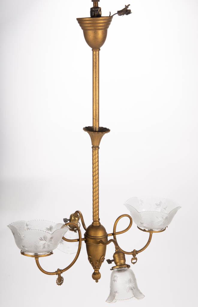 VICTORIAN BRASS GAS AND ELECTRIC CHANDELIER: VICTORIAN BRASS GAS AND ELECTRIC CHANDELIER, later brass finish, swirled central pole with blooming upper connector, ovoid central hub with four arms extending in each direction, gas arms looping. Fit
