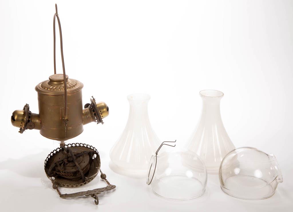 THE ANGLE LAMP CO. "PLAIN CAN" BRASS AND SHEET-IRON: THE ANGLE LAMP CO. "PLAIN CAN" BRASS AND SHEET-IRON KEROSENE HANGING ANGLE LAMP, cylinder form with two sections of raised ribs, double period lip burners, motor cover with spring-loaded motor. Fitted