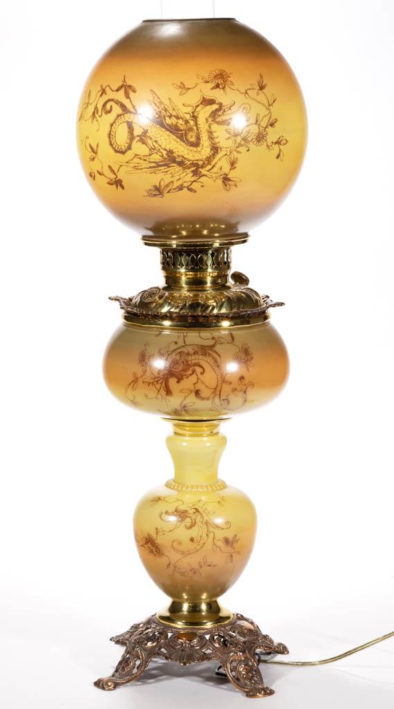 VICTORIAN STENCIL-DECORATED KEROSENE GONE WITH THE WIND: VICTORIAN STENCIL-DECORATED KEROSENE GONE WITH THE WIND / PARLOR LAMP, opal with butterscotch tones and winged griffin transfer, globular-form vase with drop-in brass font, cast-metal base with unders