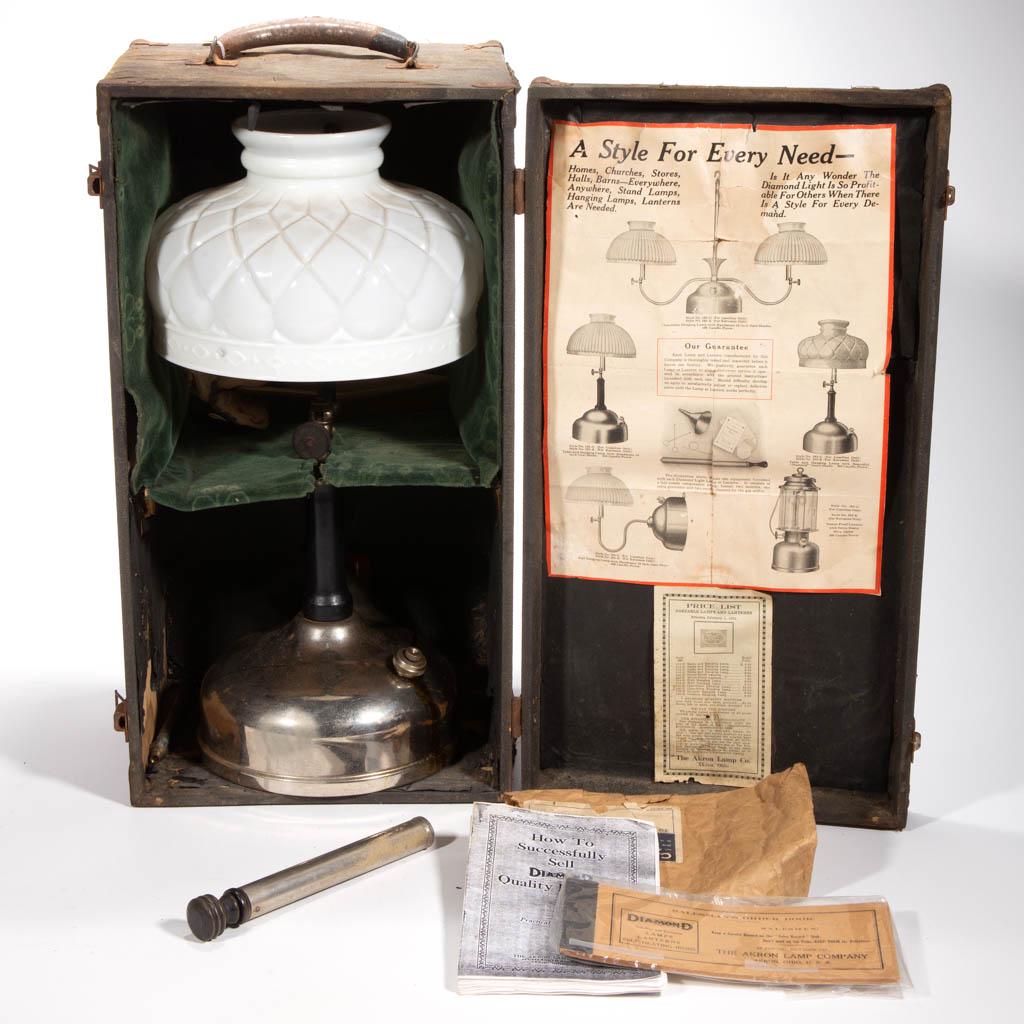 AKRON LAMP CO. "DIAMOND" NO. 102 SALESMAN SAMPLE: AKRON LAMP CO. "DIAMOND" NO. 102 SALESMAN SAMPLE PRESSURIZED GAS TABLE LAMP, nickel-plated finish, dome-form font with side refill, shaft with black enameled wooden handle, double mantles, opaque whit