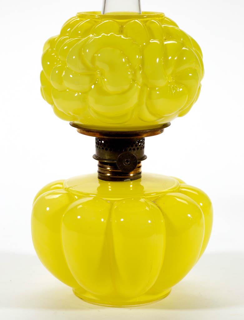 MELON RIB AND PANSY MINIATURE LAMP: MELON RIB AND PANSY MINIATURE LAMP, cased lemon yellow with glossy finish, melon-form font, as-illustrated pansy embossed compressed globular-form shade, period collar. Fitted with a Plume & Atwood Nu