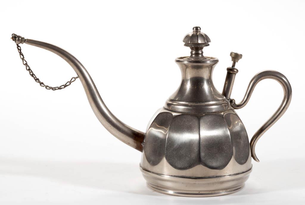 MANNING BOWMAN NICKEL-PLATED LAMP FILLER: MANNING BOWMAN NICKEL-PLATED LAMP FILLER, tapered form with oval paneled pattern, long spout and cap with original connecting chain, curled brass handle under pump, underside impressed "Manning Bowman