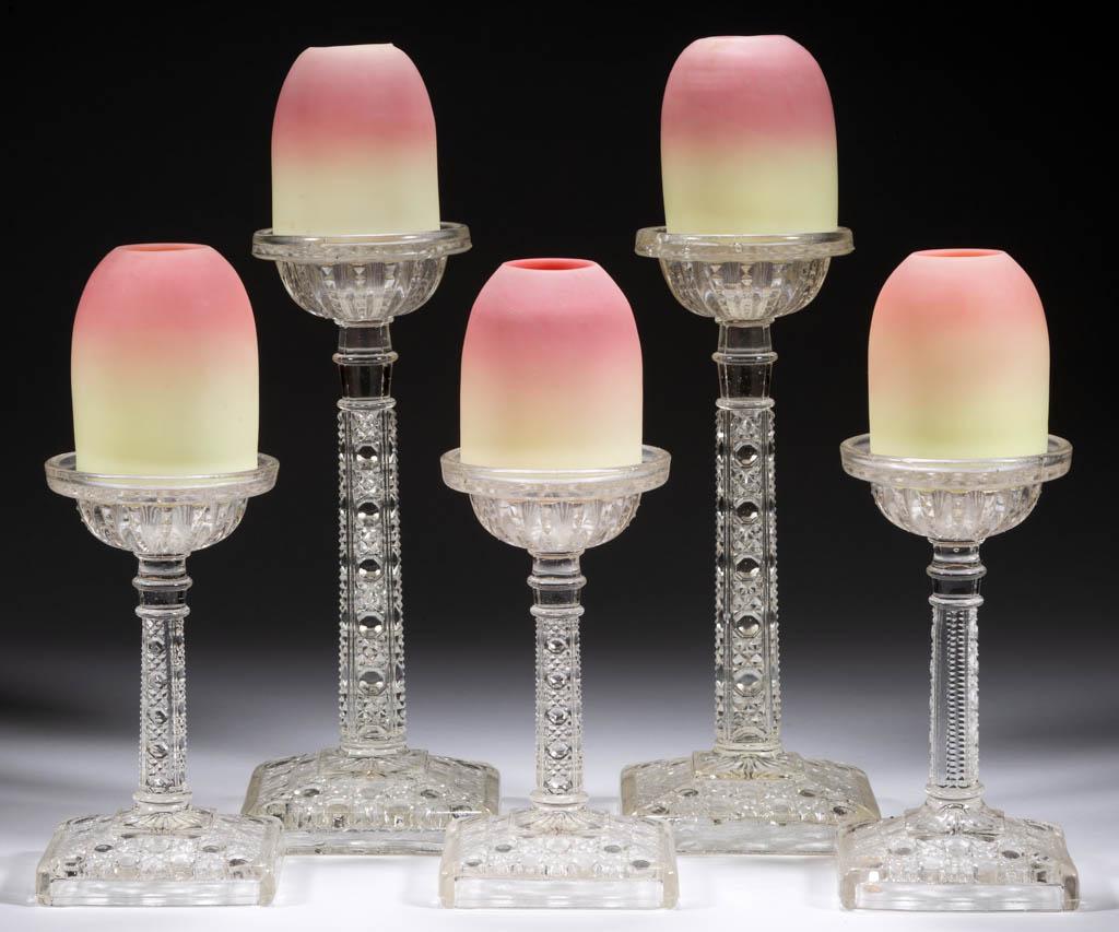 WEBB BURMESE PEDESTAL FAIRY LAMPS, LOT OF FIVE: WEBB BURMESE PEDESTAL FAIRY LAMPS, LOT OF FIVE, plush finish, each pyramid-size dome resting on a pressed glass standard with cane pattern and square foot, in two sizes. Domes by Thomas Webb & Sons. F