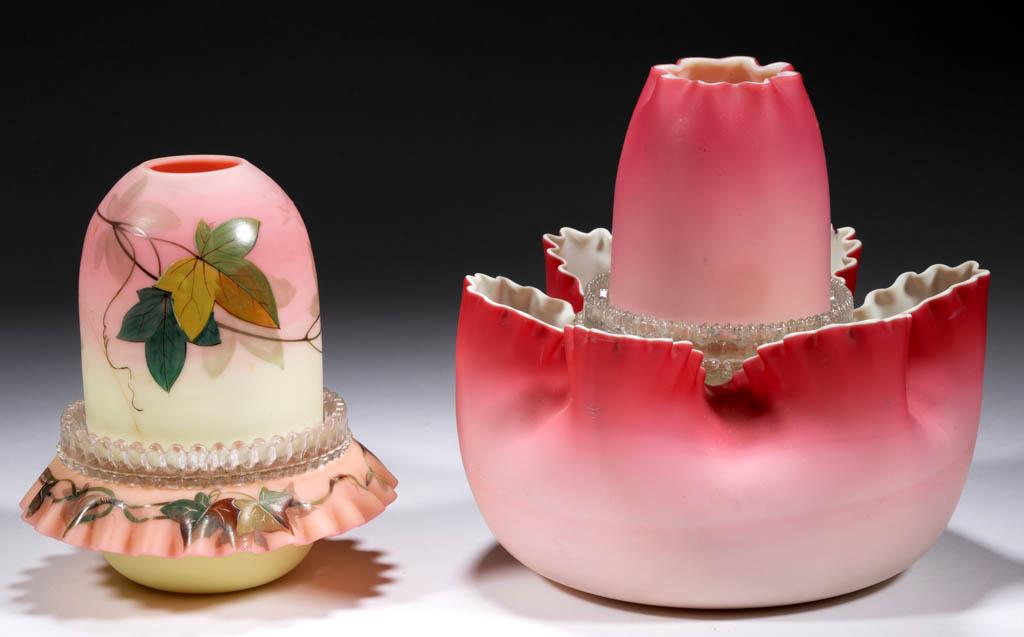 ASSORTED ART GLASS FAIRY LAMPS, LOT OF TWO: ASSORTED ART GLASS FAIRY LAMPS, LOT OF TWO, each fairy-size dome, comprising a decorated Webb Burmese dome fitted in a colorless marked Davidson lamp cup with marked candle holder, resting on a matchi