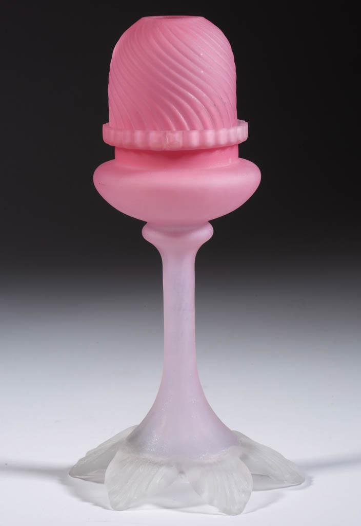 SATIN GLASS PEDESTAL FAIRY LAMP: SATIN GLASS PEDESTAL FAIRY LAMP, translucent soft pink, embossed swirled rib pyramid-size dome with two ground air vents to bottom rim, fitted in a matching lamp cup, resting in a tall panel-optic hol
