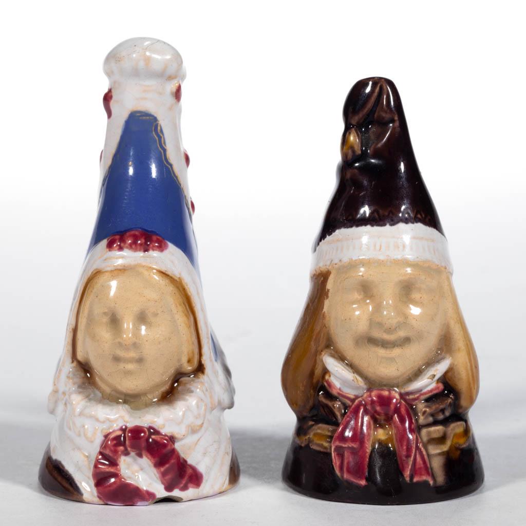 ENGLISH MINTON "NORMAN" MAJOLICA PAIR OF CANDLE: ENGLISH MINTON "NORMAN" MAJOLICA PAIR OF CANDLE SNUFFERS, comprising a girl and boy, each wearing a traditional Norman cap, having hand-painted polychrome decoration. Girl having blue hand-brushed mar