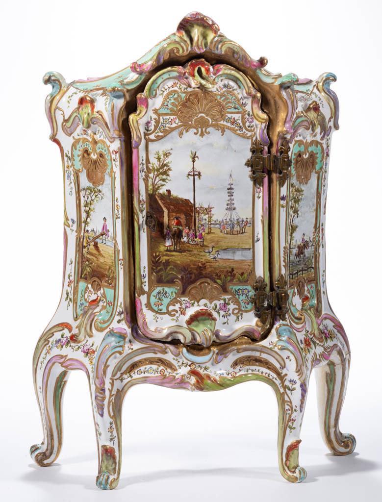 FRENCH FAIENCE TIN-GLAZED LILLE EARTHENWARE FOOTED: FRENCH FAIENCE TIN-GLAZED LILLE EARTHENWARE FOOTED MINIATURE CABINET / ARMOIRE, having central single door on brass hinges, two interior shelves, and molded acanthus leaf decorations, featuring three 