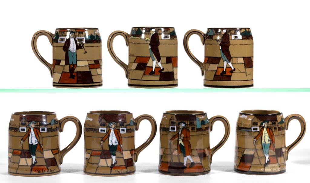 AMERICAN BUFFALO POTTERY DELDARE "YE OLDEN DAYS": AMERICAN BUFFALO POTTERY DELDARE "YE OLDEN DAYS" CERAMIC MUGS, LOT OF SEVEN, each having "Ye Lion Inn" scene featuring colonial dressed gentlemen standing on sidewalk with homes in background, legible