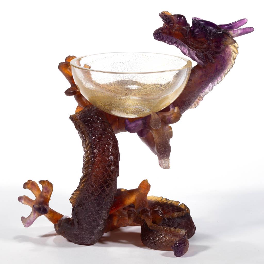 DAUM ATTRIBUTED PATE-DE-VERRE DRAGON SCULPTURE: DAUM ATTRIBUTED PATE-DE-VERRE DRAGON SCULPTURE, mixed amethyst and orange, Lindwurm dragon sitting in a twisting manner with arms holding its original aventurine cup, factory-ground base, unsigned. Fr
