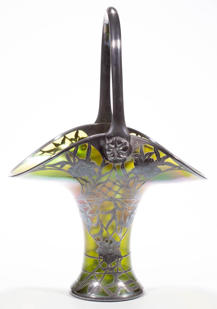 LOETZ ATTRIBUTED IRIDESCENT ART GLASS - SILVER-OVERLAY: LOETZ ATTRIBUTED IRIDESCENT ART GLASS - SILVER-OVERLAY BASKET, green iridescent, floral and latticing overlay decoration with an applied handle with prunts to the terminals, handle with overall silver