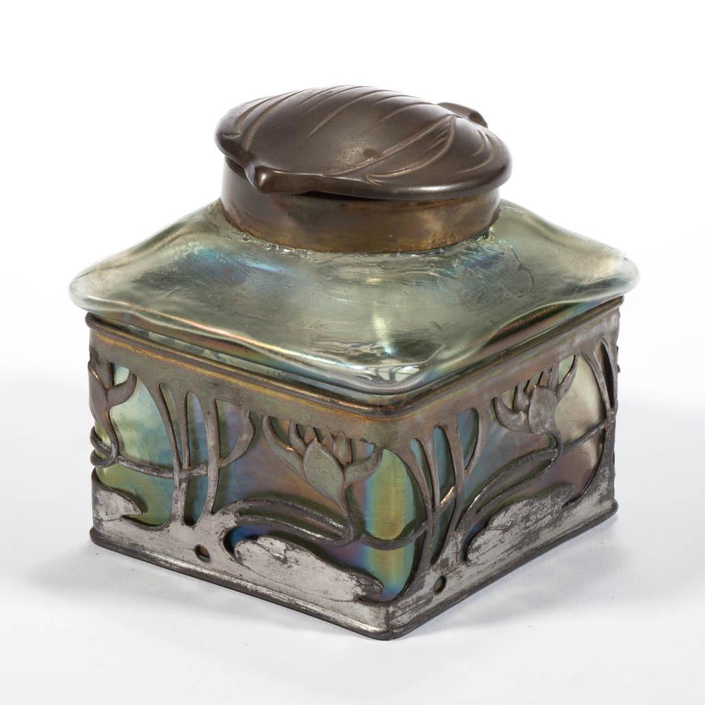 LOETZ-TYPE BOHEMIAN ART GLASS INKWELL: LOETZ-TYPE BOHEMIAN ART GLASS INKWELL, green iridescent, square form, set into a floral metal frame, with original lid. Bohemia, now Czech Republic. First quarter 20th century. 3 1/4" H, 3" SQ. Glass 