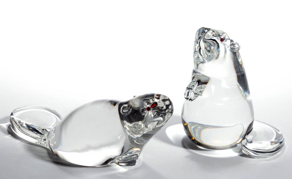 STEUBEN CRYSTAL ART GLASS BEAVER SCULPTURES, LOT OF TWO: STEUBEN CRYSTAL ART GLASS BEAVER SCULPTURES, LOT OF TWO, colorless with applied amber eyes, comprising one standing upright and the other walking forward, each having a polished base and signed "Steub