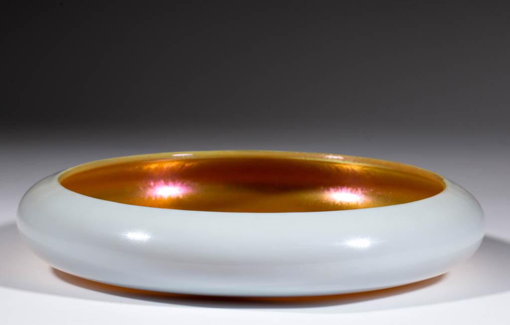 STEUBEN ATTRIBUTED GOLD CALCITE BOWL: STEUBEN ATTRIBUTED GOLD CALCITE BOWL, iridescent, low form, polished pontil mark, not signed. Steuben Glass Works. First quarter 20th century. 2" H, 9 3/4" D. Undamaged. Provenance: From the Ellen D. 