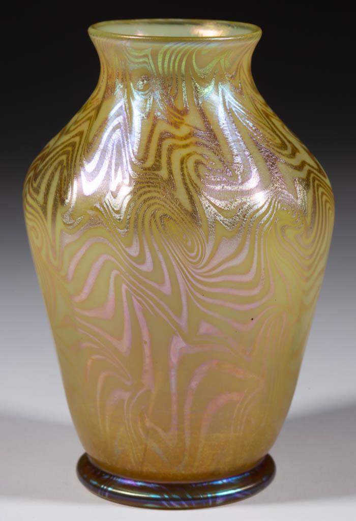 TIFFANY FAVRILE KING TUT ART GLASS VASE: TIFFANY FAVRILE KING TUT ART GLASS VASE, yellow with golden iridescent decoration, bulbous form with 14 vertical ribs, applied foot, signed "L.C.T. H 1007", polished pontil mark. Tiffany Studios. 1897