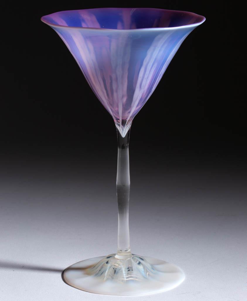 TIFFANY FAVRILE PASTEL WISTERIA ART GLASS GOBLET: TIFFANY FAVRILE PASTEL WISTERIA ART GLASS GOBLET, purple and colorless with opalescent design, conical-form bowl with shaped stem and domed foot, signed "L.C.T. / Favrile". Tiffany Studios. Circa 1930