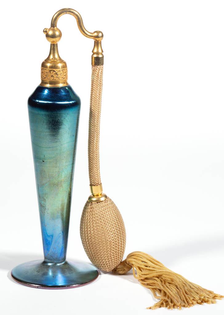STEUBEN AURENE ATTRIBUTED IRIDESCENT ART GLASS ATOMIZER: STEUBEN AURENE ATTRIBUTED IRIDESCENT ART GLASS ATOMIZER, Blue Aurene, tapered form with an applied circular foot, period mount, top, and bulb apparatus, unsigned. Steuben Glass Works. Circa 1925. 7 1/