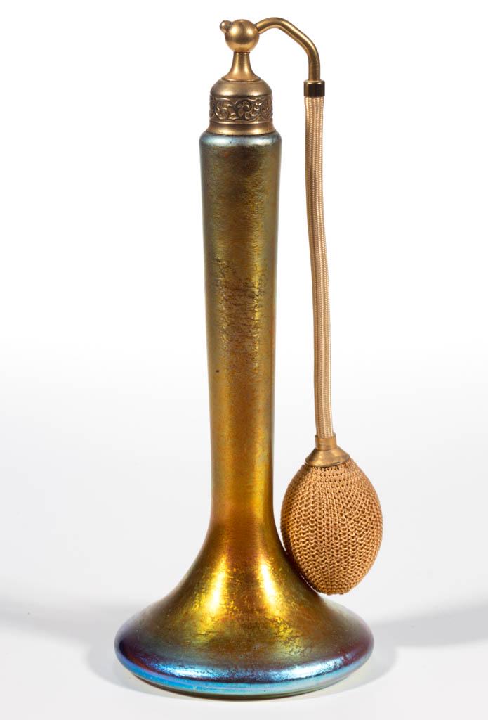 STEUBEN AURENE IRIDESCENT ART GLASS ATOMIZER: STEUBEN AURENE IRIDESCENT ART GLASS ATOMIZER, Gold Aurene, tall form with a wide base, period mount and top, and bulb apparatus, polished pontil mark signed "DeVilbiss" to the interior. Steuben Glass