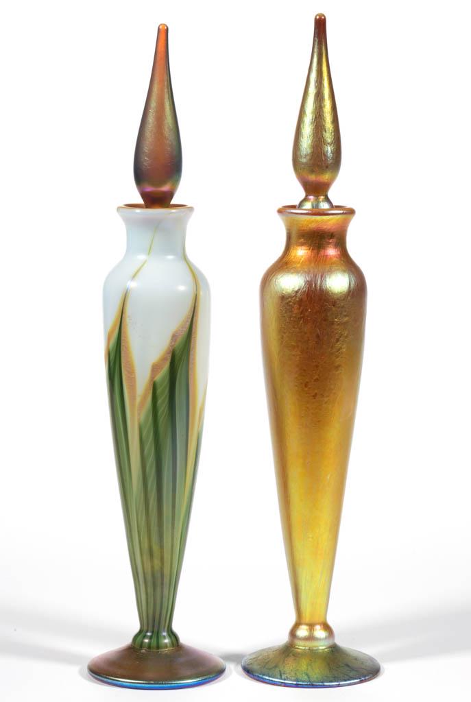 LUNDBERG STUDIOS IRIDESCENT ART GLASS PERFUME BOTTLES,: LUNDBERG STUDIOS IRIDESCENT ART GLASS PERFUME BOTTLES, LOT OF TWO, matching tall forms with one having a golden iridescent exterior and the other being Magnolia pattern, each having the original stopp