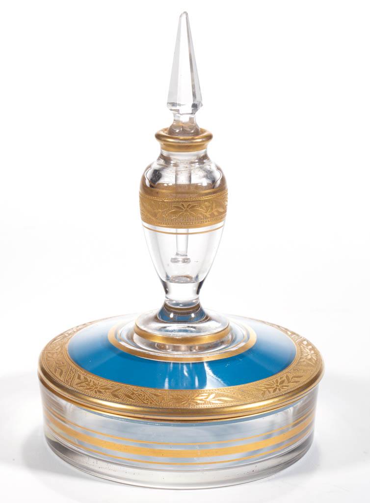 GILT FRIEZE GLASS PERFUME BOTTLE / DISH COMBINATION: GILT FRIEZE GLASS PERFUME BOTTLE / DISH COMBINATION, colorless with blue and gilt decoration, perfume bottle to the top being fitted with a cut steeple-form stopper with dauber and terminating in the