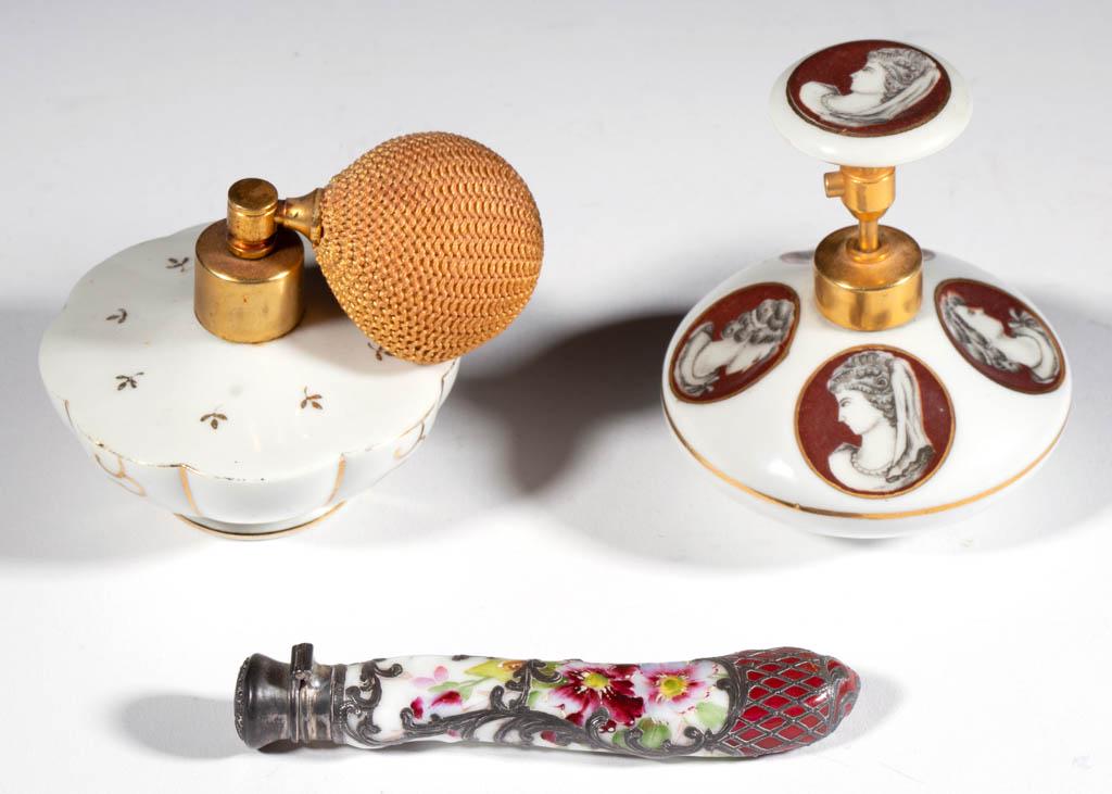 ASSORTED PORCELAIN PERFUME ARTICLES, LOT OF THREE: ASSORTED PORCELAIN PERFUME ARTICLES, LOT OF THREE, comprising a 4 1/8" L silver-overlay scent bottle having polychrome hand-painted floral decoration, and two atomizers, including one featuring five h