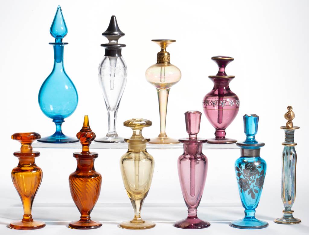 ASSORTED GLASS PERFUME BOTTLES, LOT OF TEN: ASSORTED GLASS PERFUME BOTTLES, LOT OF TEN, various colors, including an engraved example with silver-overlay, an amber swirl, and an amber iridescent. DeVilbiss and others. First half 20th century. 4