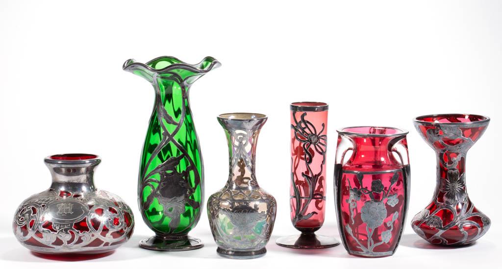 ASSORTED ART NOUVEAU SILVER-OVERLAY AND GLASS VASES,: ASSORTED ART NOUVEAU SILVER-OVERLAY AND GLASS VASES, LOT OF SIX, comprising a colorless iridescent example with scrolled design having "SCM" inscribed to front, a green fluted form example, and four c