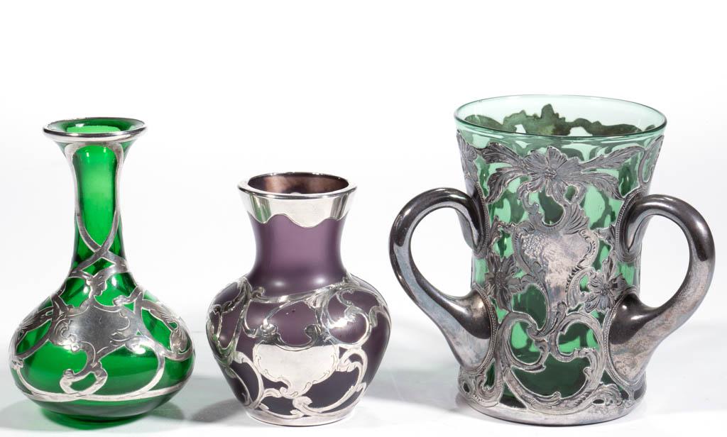 ASSORTED ART NOUVEAU SILVER-OVERLAY AND GLASS ARTICLES,: ASSORTED ART NOUVEAU SILVER-OVERLAY AND GLASS ARTICLES, LOT OF THREE, comprising a green three-handled loving cup with rayed base, featuring floral and scrolled decoration, having .999 silver fineness