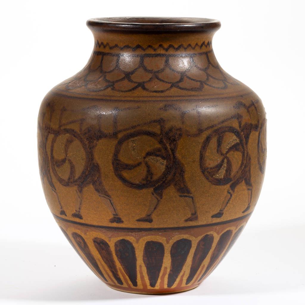 JAMES R. CARLEY (1909-2006) NORTH DAKOTA SCHOOL OF: JAMES R. CARLEY (1909-2006) NORTH DAKOTA SCHOOL OF MINES ART POTTERY VASE, of ovoid form with matte glaze featuring a central band of brown stenciled images of ancient Etruscan hoplites carrying spear