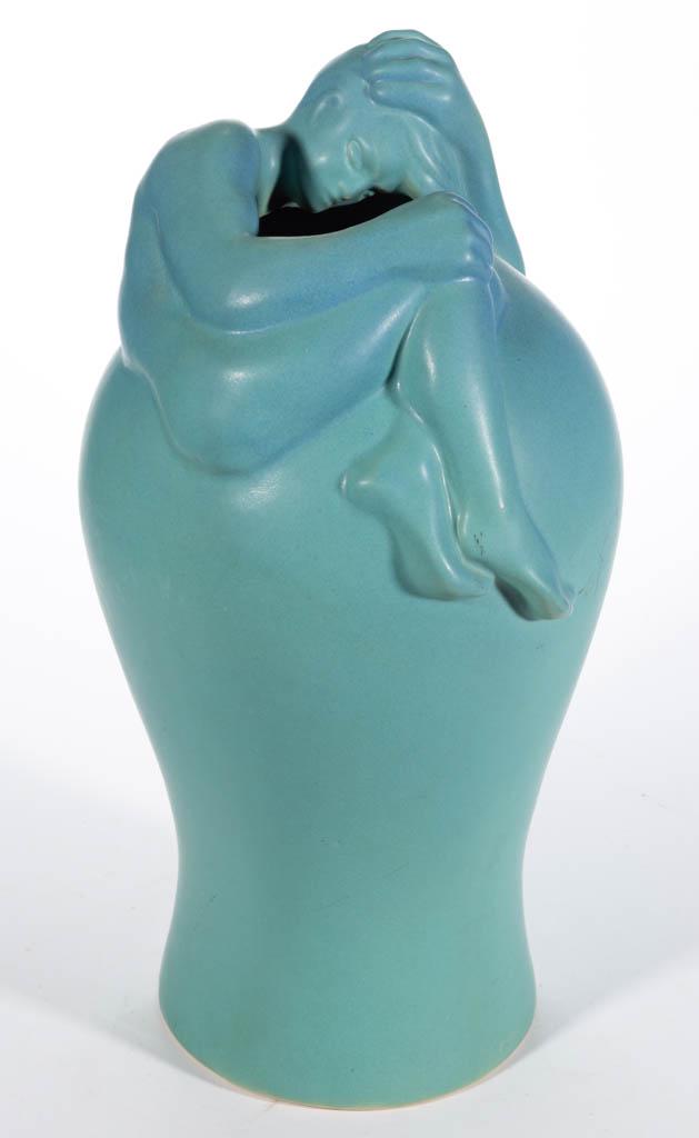 VAN BRIGGLE "DESPONDENCY" ART POTTERY VASE: VAN BRIGGLE "DESPONDENCY" ART POTTERY VASE, having turquoise or "Ming blue" matte glaze featuring a figure enveloping the rim with left hand resting on top of head. Having incised logo mark to undersi