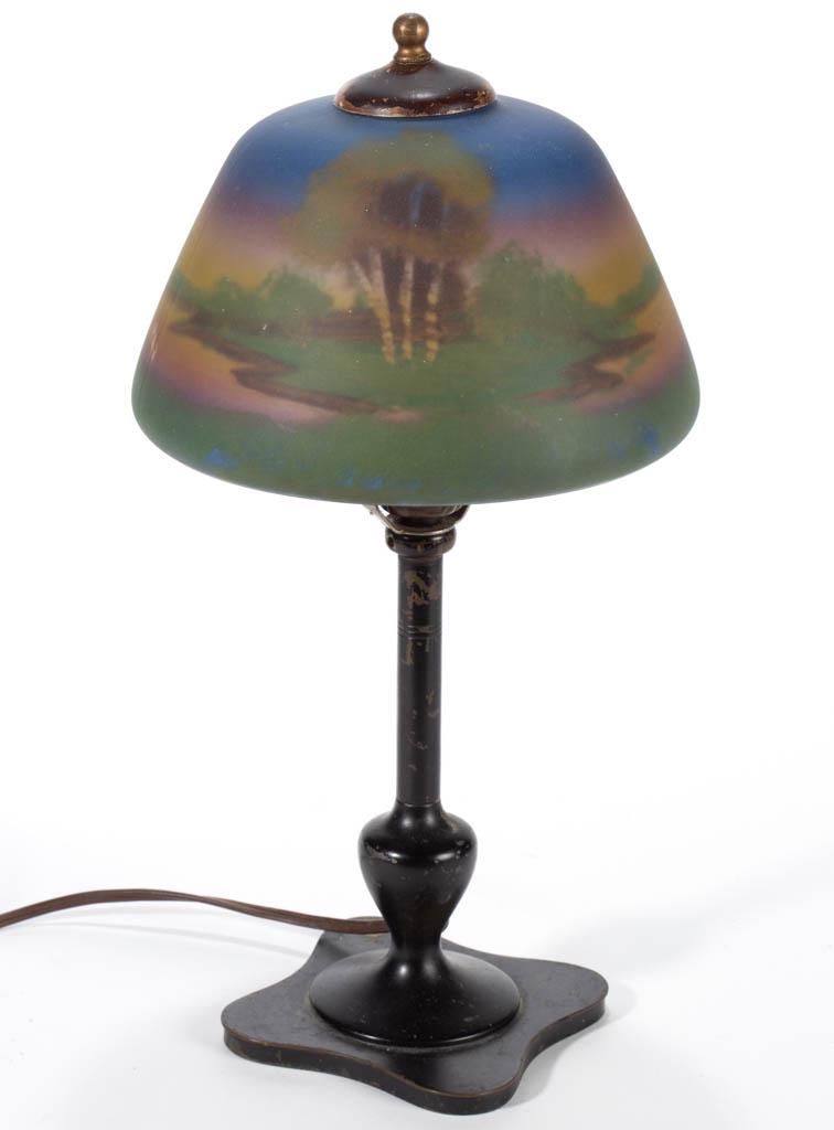 REVERSE-PAINTED ELECTRIC BOUDOIR LAMP: REVERSE-PAINTED ELECTRIC BOUDOIR LAMP, polychrome-enamel decorated domed shade with landscape scene, raised on a brass lamp base with an ebony finish, single-socket with a harp support, with heat cap
