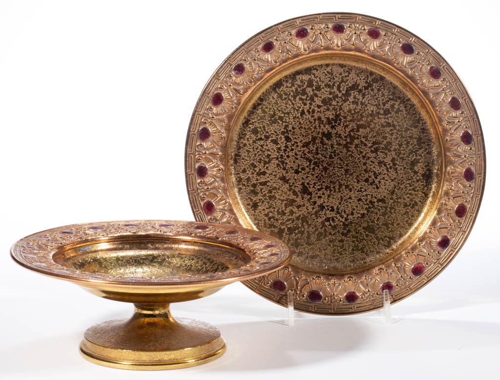 TIFFANY FURNACES NO. 309 AND NO. 504 BRONZE AND ENAMEL: TIFFANY FURNACES NO. 309 AND NO. 504 BRONZE AND ENAMEL TABLE ARTICLES, LOT OF TWO, comprising a compote and a plate, each having matching plum enameled medallions, each signed to the underside "LOUIS 