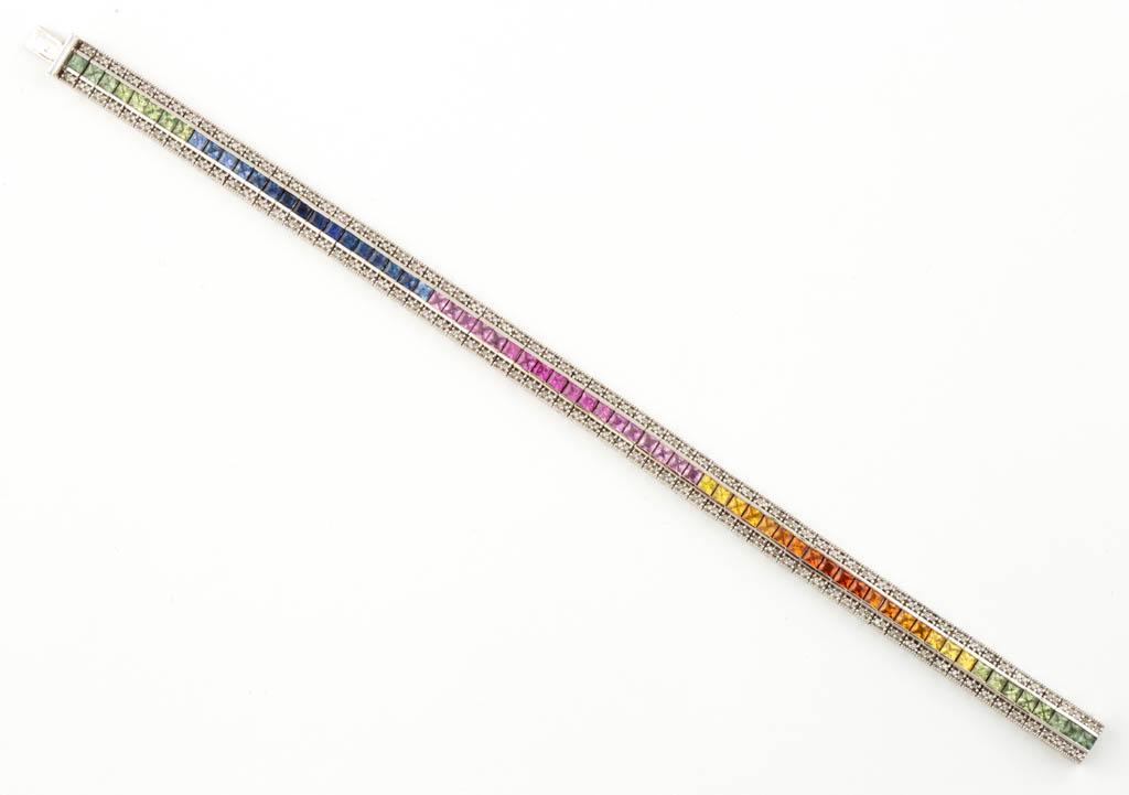 14K WHITE GOLD RAINBOW SAPPHIRE AND DIAMOND TENNIS: 14K WHITE GOLD RAINBOW SAPPHIRE AND DIAMOND TENNIS BRACELET, bracelet with rectangular 7.4 mm wide links having hidden box clasp; featuring 68 2.5 mm square-cut sapphires in varying tones of green, or