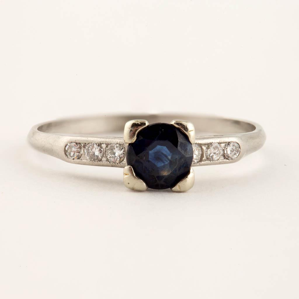 VINTAGE PLATINUM SAPPHIRE SOLITAIRE AND DIAMOND LADY'S: VINTAGE PLATINUM SAPPHIRE SOLITAIRE AND DIAMOND LADY'S RING, 0.900 platinum band featuring one 5.2 mm round-faceted sapphire in a four-prong setting, flanked by six round-cut melee diamonds. Impressed