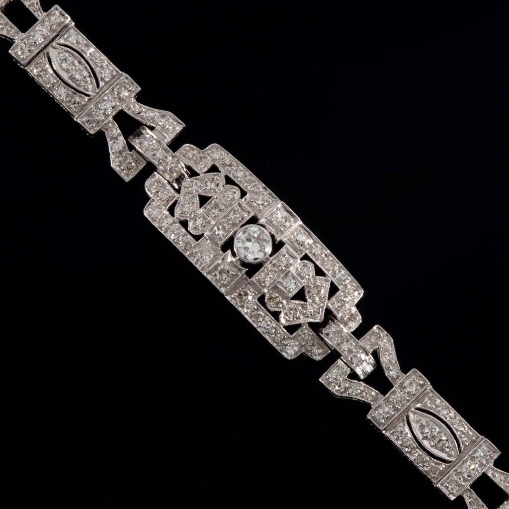 EDWARDIAN PLATINUM AND DIAMOND BRACELET: EDWARDIAN PLATINUM AND DIAMOND BRACELET, fancy-link design having a folding clasp with marked 14K white gold safety chain, set with a center round-cut diamond measuring approximately 3.6 x 2 mm having