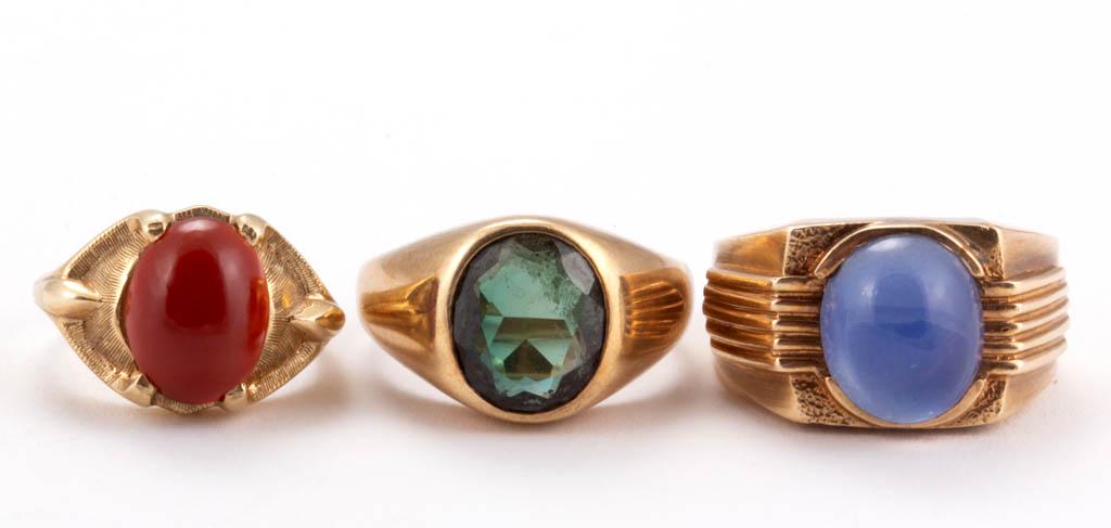 VINTAGE 10K YELLOW GOLD AND STONE RINGS, LOT OF THREE: VINTAGE 10K YELLOW GOLD AND STONE RINGS, LOT OF THREE, comprising one with an oval-cut grey-green stone, one with a light blue cabochon stone, and one with an oval red cabochon stone. Each with "10K" 