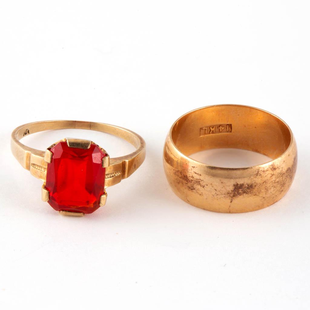 ANTIQUE / VINTAGE 10K AND 14K YELLOW GOLD RINGS, LOT OF: ANTIQUE / VINTAGE 10K AND 14K YELLOW GOLD RINGS, LOT OF TWO, comprising a wide 14K gold band, and a 10K example with a red glass stone. Band with "14KL" mark, other with slightly worn "10..." mark. To