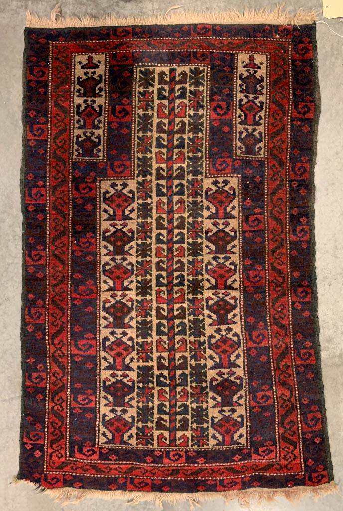 SEMI-ANTIQUE AFGHAN BALUCH ORIENTAL PRAYER RUG: SEMI-ANTIQUE AFGHAN BALUCH ORIENTAL PRAYER RUG, red and blue ground. First half 20th century. 4' 2" x 2' 8". Very good overall condition, minor wear to edges and fringe, and with areas of expected usa