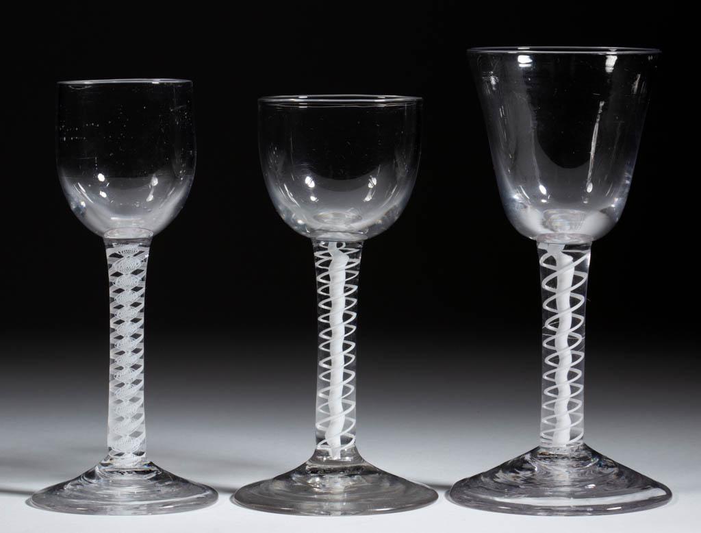 ENGLISH FREE-BLOWN OPAQUE-TWIST WINE GLASSES, LOT OF: ENGLISH FREE-BLOWN OPAQUE-TWIST WINE GLASSES, LOT OF THREE, colorless lead glass, comprising a round funnel bowl raised on a stem containing a pair of heavy spiral threads outside solid vertical cable