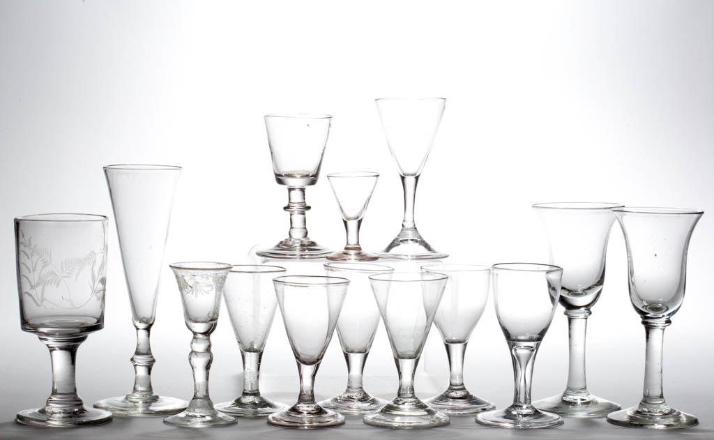 ASSORTED FREE-BLOWN DRINKING VESSELS, LOT OF 14: ASSORTED FREE-BLOWN DRINKING VESSELS, LOT OF 14, colorless lead and non-lead glass, including wine glasses, a cordial glass, and a flute, various bowls and stems, eight with folded foot, 12 with rough