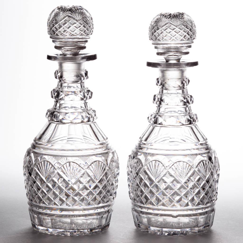 CUT STRAWBERRY DIAMONDS AND FANS PAIR OF PINT DECANTERS: CUT STRAWBERRY DIAMONDS AND FANS PAIR OF PINT DECANTERS, colorless lead glass, each shouldered form with many stacked diamonds topped by fans, three applied and cut-faceted neck rings, original matchi