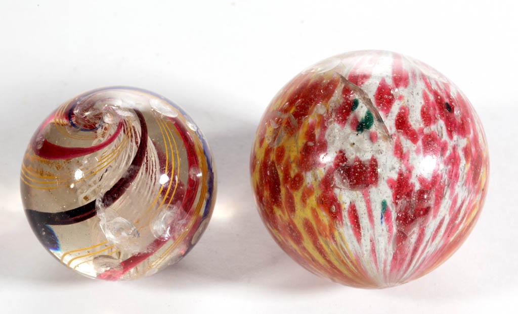 ASSORTED BLOWN GLASS MARBLES, LOT OF TWO: ASSORTED BLOWN GLASS MARBLES, LOT OF TWO, comprising a large onionskin with opal, cranberry, and yellow mottling, and a transparent swirl with exterior blue, cranberry, and maroon swirls. Various make