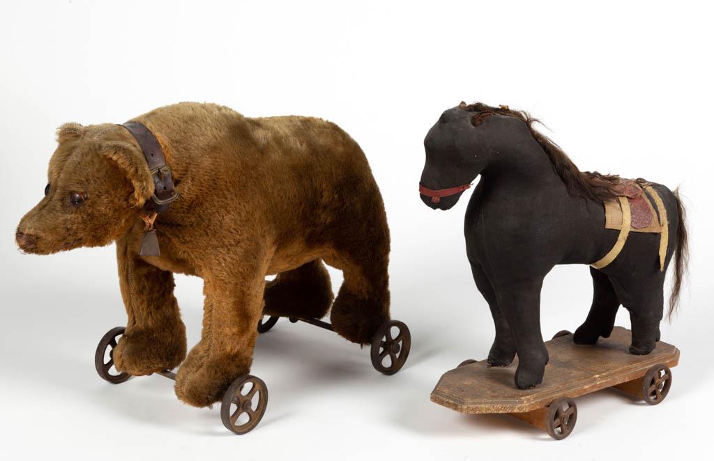 ANTIQUE FIGURAL ANIMAL PULL TOYS, LOT OF TWO: ANTIQUE FIGURAL ANIMAL PULL TOYS, LOT OF TWO, comprising a mohair bear wearing a leather collar with bell, and one fabric-covered horse. Fourth quarter 19th/first quarter 20th century. Bear 10 3/4" HO