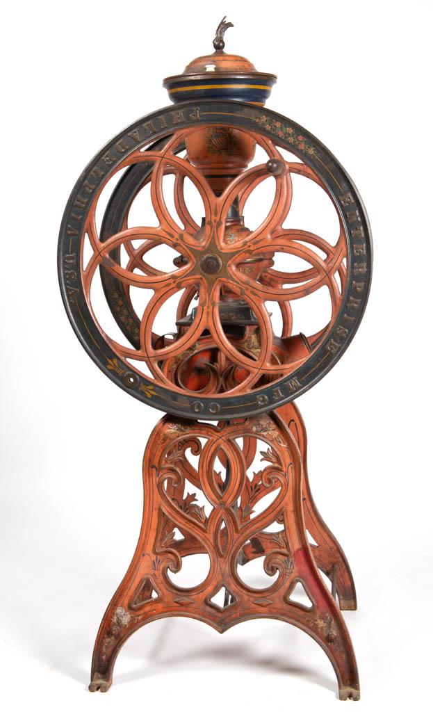 ENTERPRISE NO. 16 CAST-IRON TWO-WHEEL FLOOR MODEL: ENTERPRISE NO. 16 CAST-IRON TWO-WHEEL FLOOR MODEL COFFEE MILL / GRINDER, swivel lid with eagle finial, raised on an ornate cast-iron base with likely original removable pan, retains original paint and