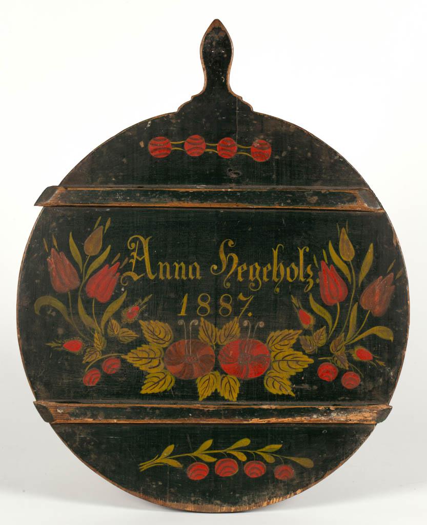SCANDINAVIAN PAINT-DECORATED PINE DOUGH / CUTTING BOARD: SCANDINAVIAN PAINT-DECORATED PINE DOUGH / CUTTING BOARD, for "Anna Hegehlz. / 1887", with floral designs, possibly tulips. Retains likely original polychrome-painted surface. Dated 1887. 25 3/4" HOA, 