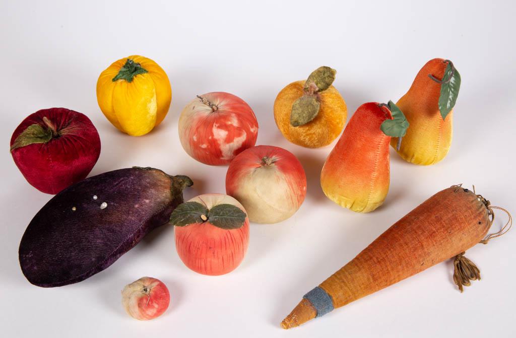 ASSORTED VELVET FIGURAL PINCUSHIONS, LOT OF 11: ASSORTED VELVET FIGURAL PINCUSHIONS, LOT OF 11, including carrot with make-do top and inked embellishments, egg plant with green stem, and a yellow pepper. Fourth quarter of 19th century, some example