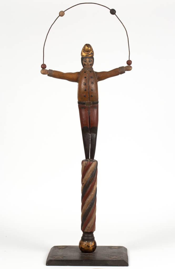 CONTEMPORARY FOLK ART CARVED AND PAINTED WHIMSY: CONTEMPORARY FOLK ART CARVED AND PAINTED WHIMSY, depicting a juggler standing atop a barber's pole, base with stars on the corners, no signature located. Retains likely original polychrome-painted sur