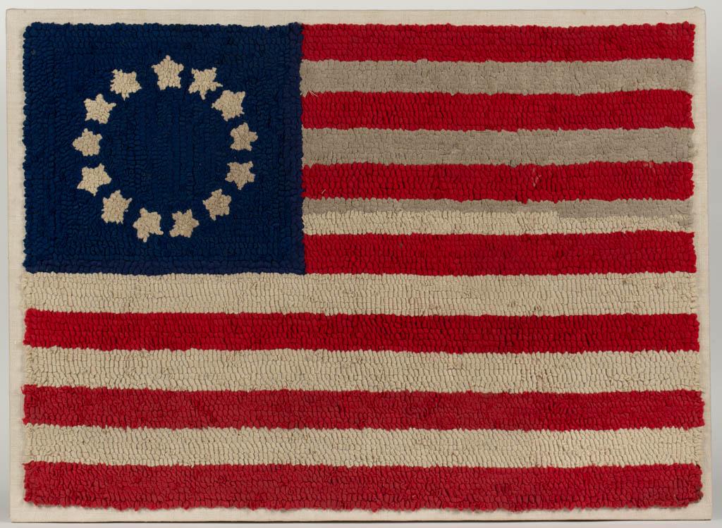 AMERICAN FOLK ART PATRIOTIC HOOKED RUG: AMERICAN FOLK ART PATRIOTIC HOOKED RUG, mixed fabrics on burlap, depicting a Betsy Ross-style American Flag, with 13 stripes, and 13 five-pointed stars. Mounted for display. Late 19th/first quarter 20