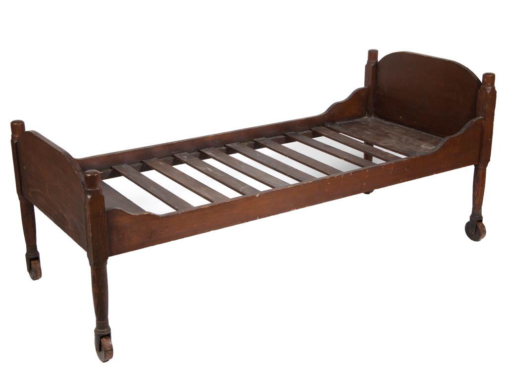SHAKER POPLAR AND CHESTNUT BED: SHAKER POPLAR AND CHESTNUT BED, shaped headboard and turned legs fitted with original cast-iron sockets and wooden rollers. Early, possibly original, varnished surface with rich color. Possibly Mount