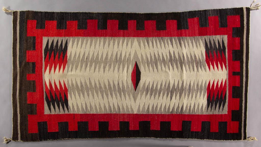 NAVAJO REGIONAL WEAVING / RUG: NAVAJO REGIONAL WEAVING / RUG, with colors of black, red, gray, and white. Possibly Ganado. Third quarter 20th century. 6' 1/2" x 3' 4 3/4". Very good overall condition with areas of expected usage we