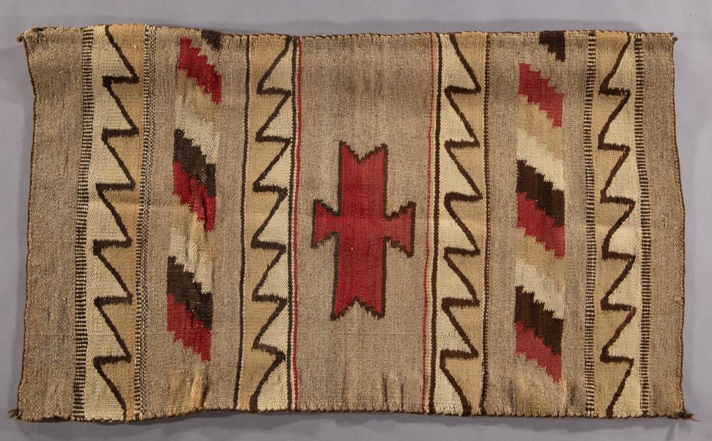 NATIVE AMERICAN NAVAJO-STYLE WOOL RUG / WEAVING: NATIVE AMERICAN NAVAJO-STYLE WOOL RUG / WEAVING, earth-toned with red colors, central geometric design, and zig-zag patterns, with added wooded strip for display. 20th century. 25" x 41". Very good ov